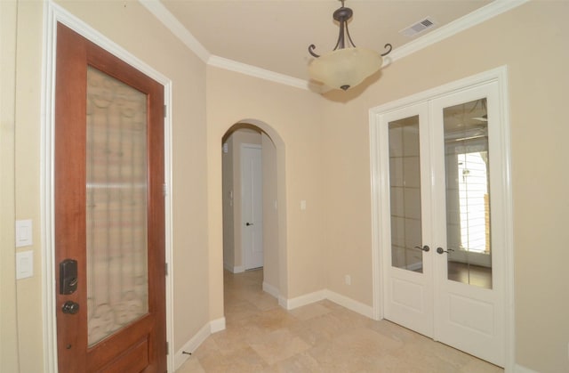 entrance foyer with french doors, visible vents, arched walkways, baseboards, and ornamental molding