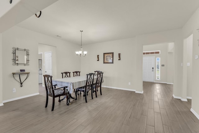 23134 Quiet Heron Ct, Katy, TX 77493 - dining space with wood finished floors, baseboards, and a chandelier