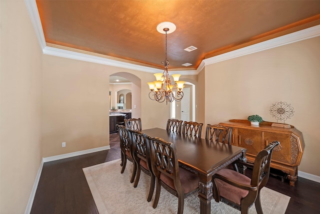 dining space with arched walkways, visible vents, a chandelier, and dark wood finished floors
