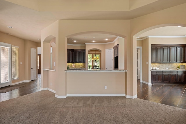 kitchen featuring recessed lighting, backsplash, and dark brown cabinets