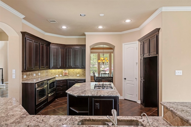 kitchen featuring visible vents, arched walkways, a sink, a chandelier, and stainless steel appliances