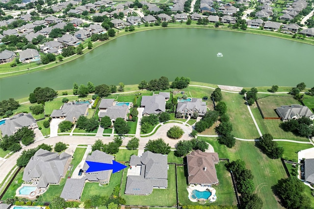 drone / aerial view with a water view and a residential view