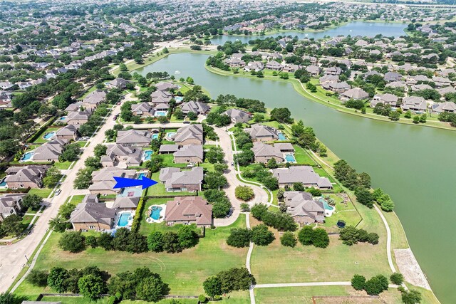 birds eye view of property with a water view and a residential view