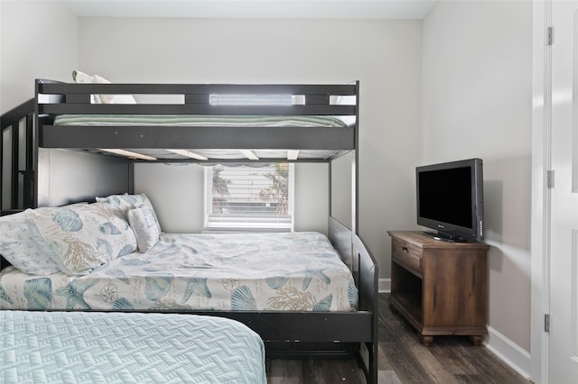 bedroom featuring wood finished floors and baseboards
