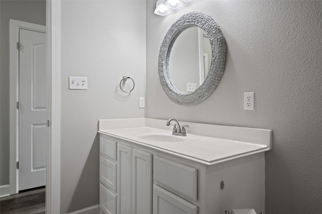 bathroom with vanity and wood finished floors