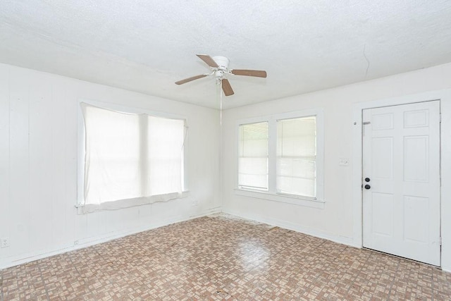 1817 Mcdaniel St, Houston, TX 77093 - unfurnished living room featuring a ceiling fan and a textured ceiling