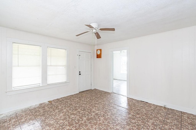 1817 Mcdaniel St, Houston, TX 77093 - spare room with baseboards, a ceiling fan, and a textured ceiling