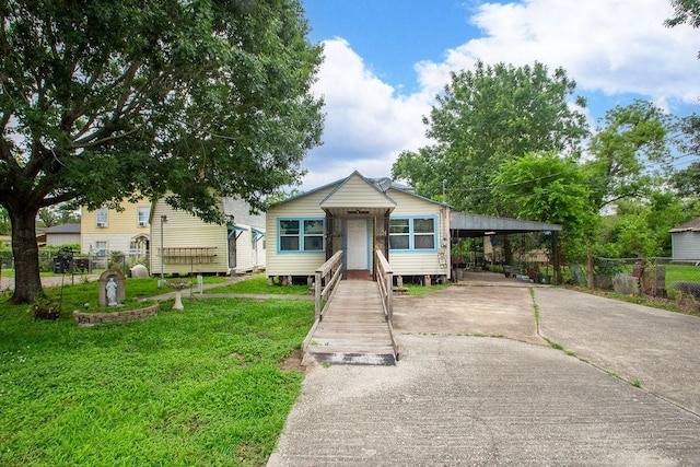 1817 Mcdaniel St, Houston, TX 77093 - bungalow-style house with concrete driveway, fence, a front yard, and an attached carport