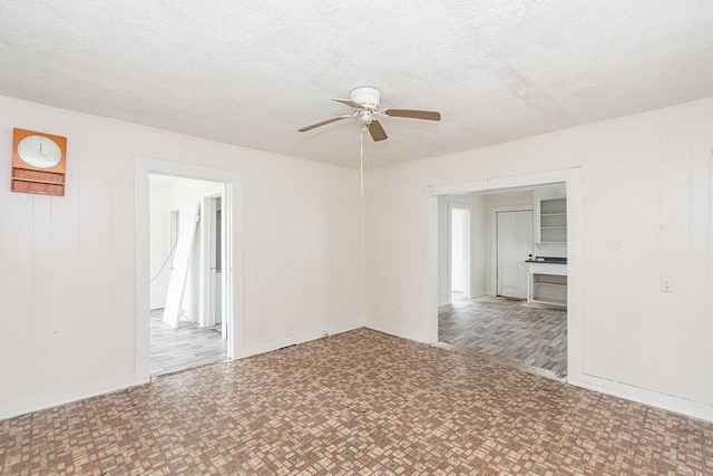 1817 Mcdaniel St, Houston, TX 77093 - empty room featuring baseboards, ceiling fan, and a textured ceiling