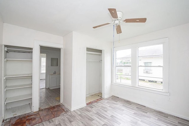 1817 Mcdaniel St, Houston, TX 77093 - unfurnished bedroom featuring baseboards, ceiling fan, wood finished floors, and a closet