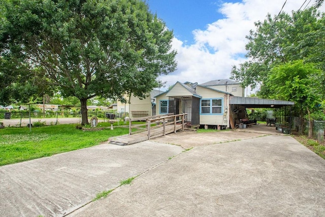 1817 Mcdaniel St, Houston, TX 77093 - view of front of house with fence, concrete driveway, an attached carport, and a front lawn