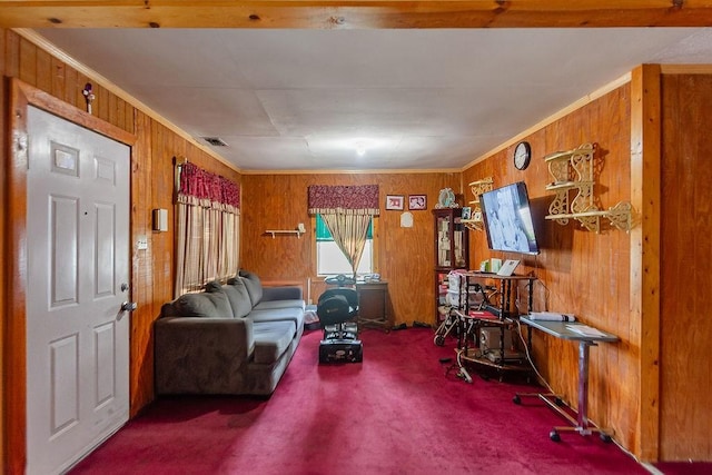 1817 Mcdaniel St, Houston, TX 77093 - living room featuring wooden walls, crown molding, visible vents, and carpet