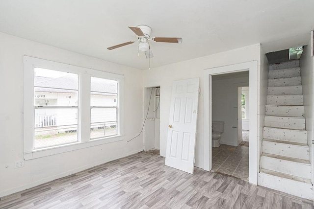 1817 Mcdaniel St, Houston, TX 77093 - unfurnished bedroom featuring baseboards, multiple windows, light wood-type flooring, and connected bathroom