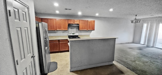 kitchen with under cabinet range hood, recessed lighting, appliances with stainless steel finishes, and light countertops