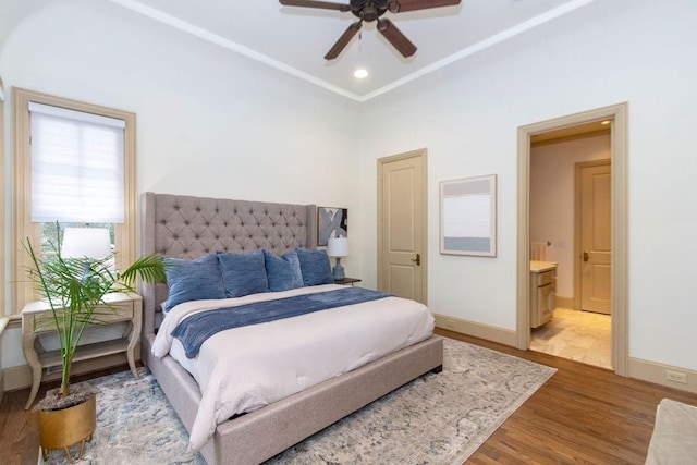 5262 Huckleberry Ln, Houston, TX 77056 - bedroom with wood finished floors, baseboards, ensuite bath, and a ceiling fan