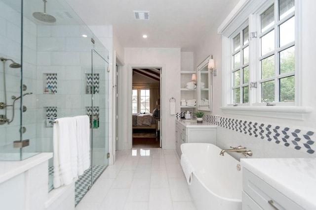 ensuite bathroom with a freestanding bath, plenty of natural light, ensuite bathroom, and a shower stall