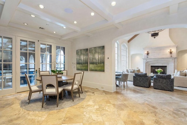 5262 Huckleberry Ln, Houston, TX 77056 - dining room featuring beam ceiling, french doors, recessed lighting, a premium fireplace, and arched walkways