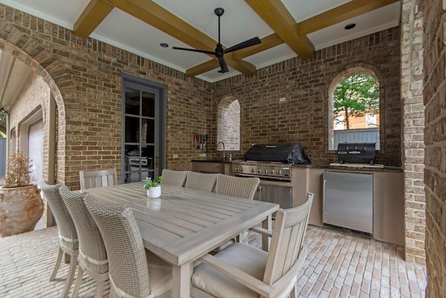 view of patio featuring an outdoor kitchen, ceiling fan, outdoor dining area, a sink, and a grill