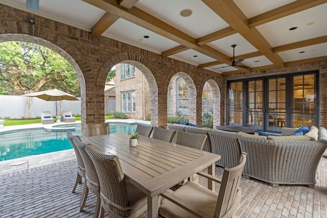 view of patio with a ceiling fan, a pool with connected hot tub, fence, and an outdoor hangout area