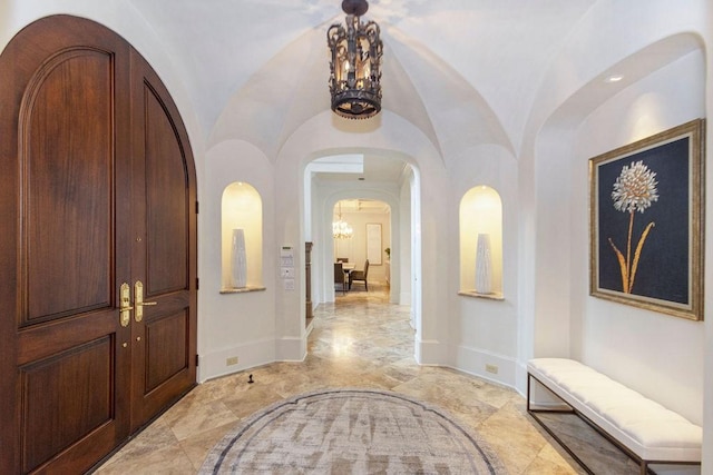 5262 Huckleberry Ln, Houston, TX 77056 - entrance foyer with a chandelier, arched walkways, light marble finish flooring, and baseboards