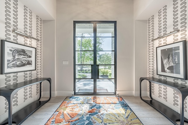 entrance foyer with baseboards and wood finished floors