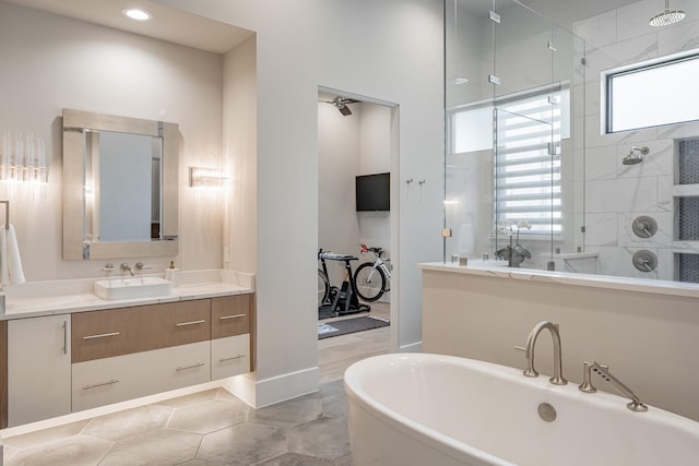 full bath featuring vanity, recessed lighting, a freestanding tub, and a shower stall