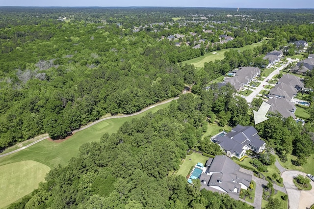 birds eye view of property with a residential view, view of golf course, and a wooded view