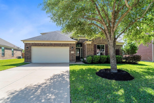 single story home featuring a garage, a front yard, driveway, and brick siding