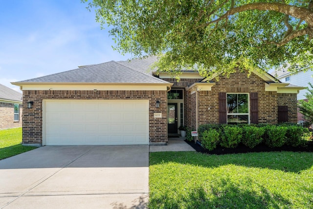 single story home with a shingled roof, an attached garage, brick siding, a front yard, and concrete driveway