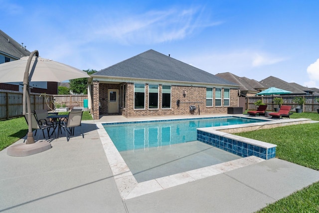 view of pool with a lawn, a fenced in pool, a fenced backyard, and a patio area