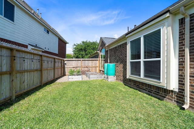 view of yard with fence and a garden