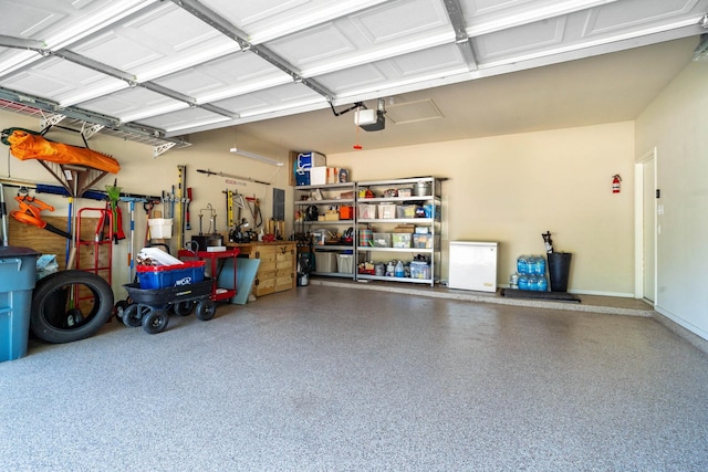 garage with a garage door opener and fridge
