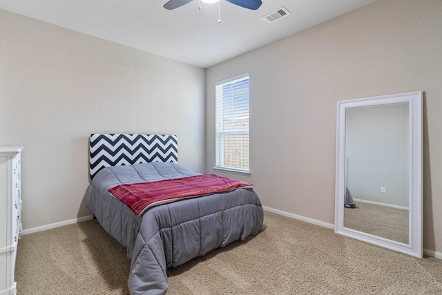 bedroom with carpet flooring, a ceiling fan, baseboards, and visible vents