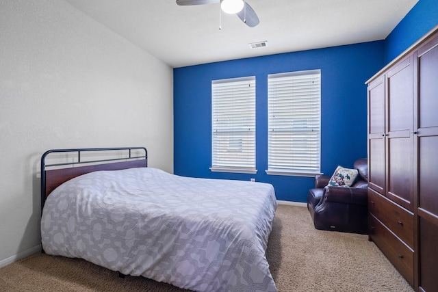 carpeted bedroom featuring baseboards, visible vents, and ceiling fan