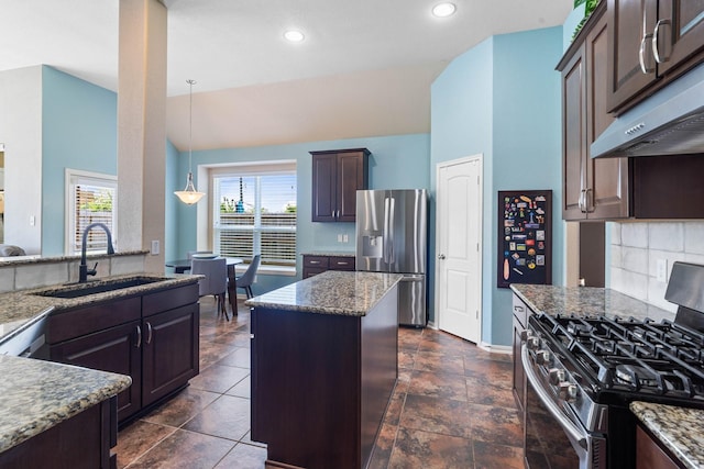 kitchen with a sink, appliances with stainless steel finishes, plenty of natural light, and stone counters