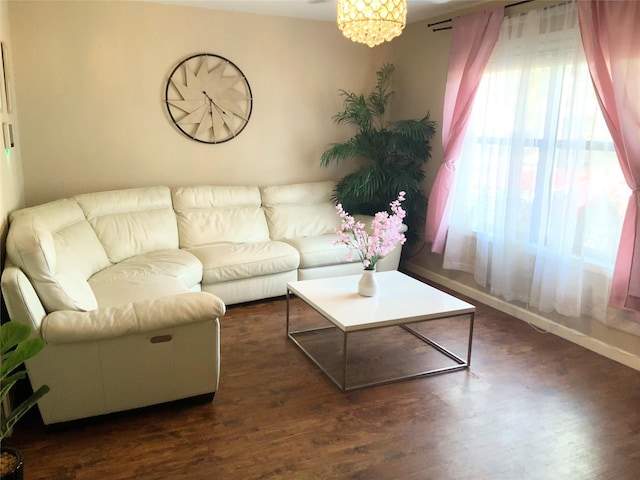 living area featuring baseboards and dark wood finished floors