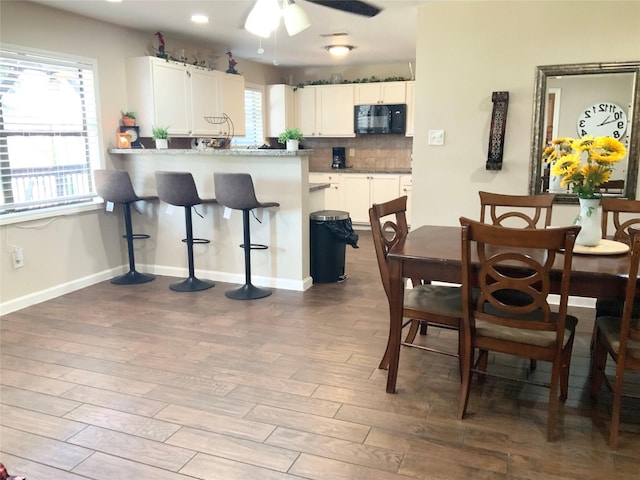 dining area with baseboards, recessed lighting, ceiling fan, and wood finished floors
