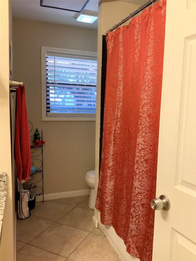 bathroom featuring vanity, curtained shower, toilet, baseboards, and tile patterned floors