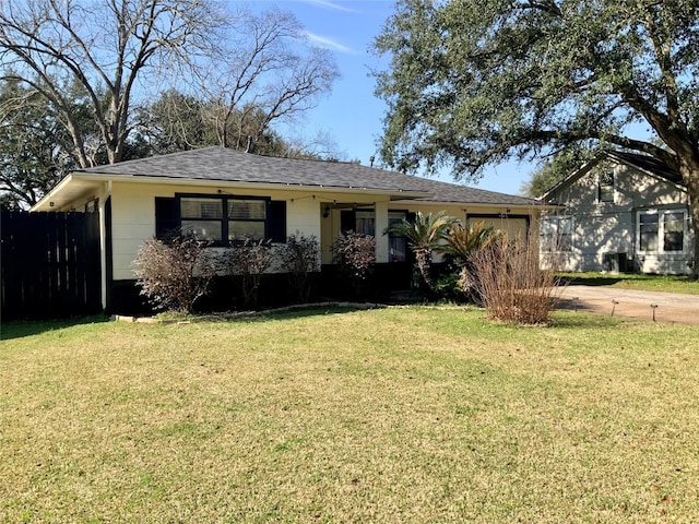 view of front of home with a garage, fence, a front yard, roof with shingles, and driveway