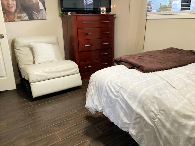 bedroom with dark wood-type flooring
