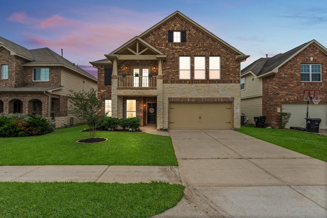 traditional-style house featuring a front lawn, a balcony, brick siding, concrete driveway, and an attached garage