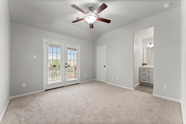 unfurnished bedroom featuring baseboards, access to outside, connected bathroom, and light colored carpet
