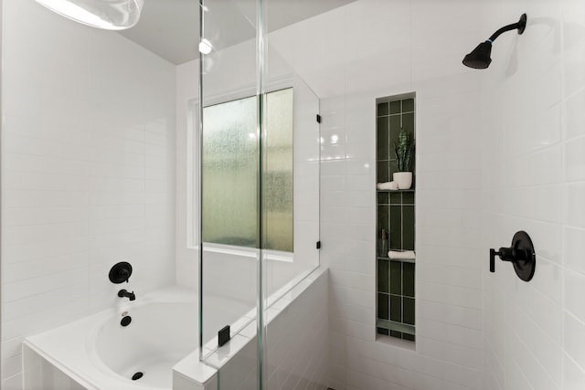 full bath with tiled shower and a bath