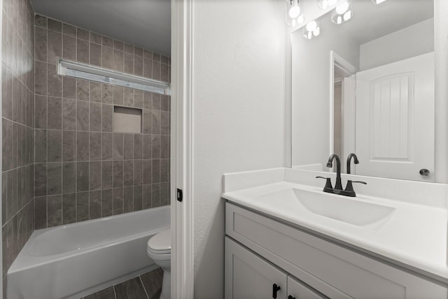 full bathroom with vanity, shower / tub combination, and toilet