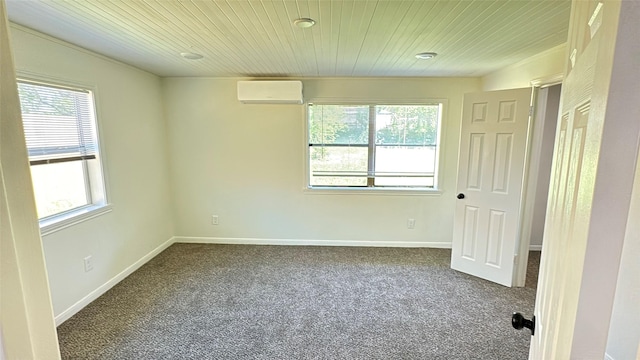 spare room with wood ceiling, dark carpet, and a wealth of natural light