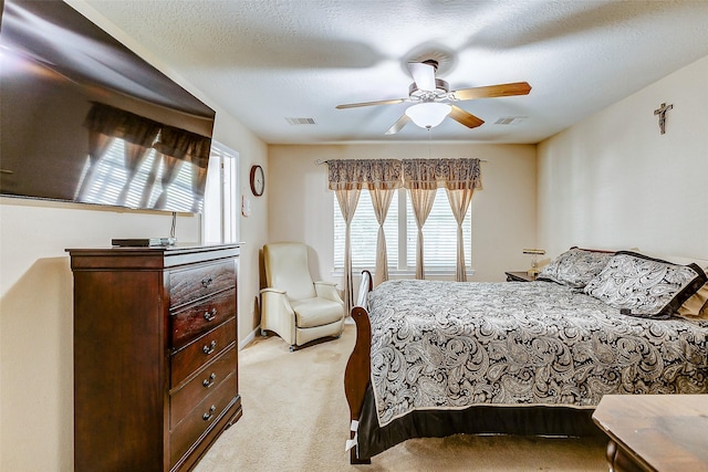 bedroom featuring visible vents, light carpet, and multiple windows