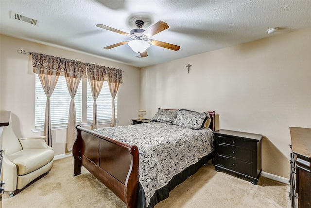 bedroom with visible vents, baseboards, ceiling fan, and light colored carpet