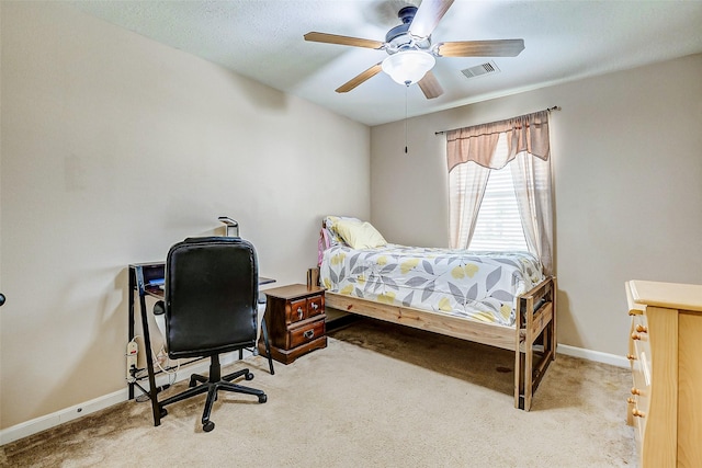 carpeted bedroom with baseboards, ceiling fan, and visible vents
