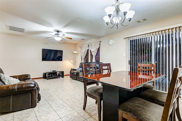 dining room featuring baseboards, visible vents, light tile patterned floors, and ceiling fan with notable chandelier