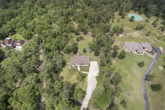 bird's eye view with a wooded view